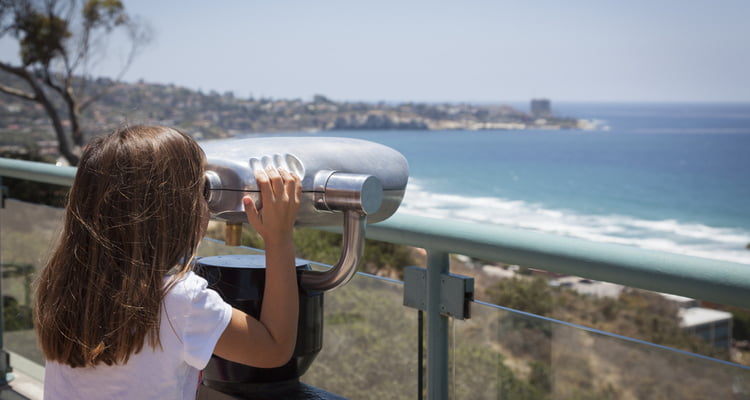 san diego kid looking over water san diego charter bus company