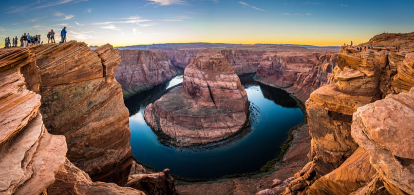 visitors watching sunset at horseshoe bend arizona