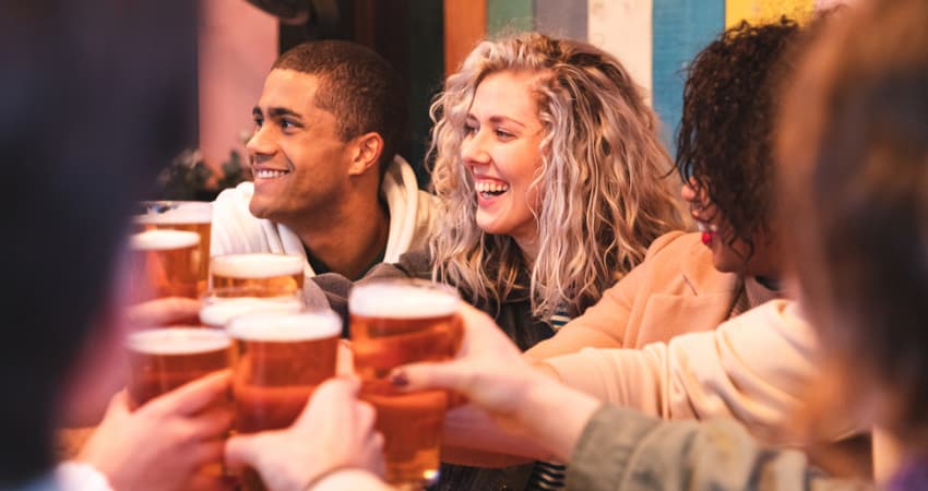 A group fo friends toasting beers at a brewery