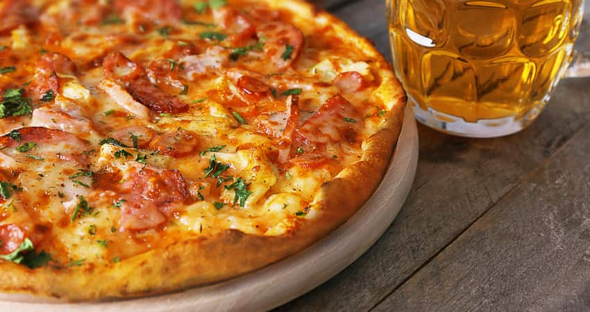 Close up of a pizza and beer