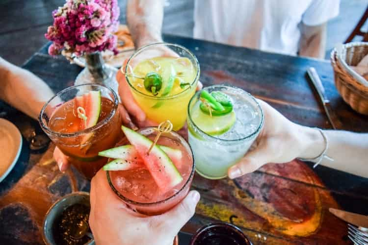 Four people drinking cocktails