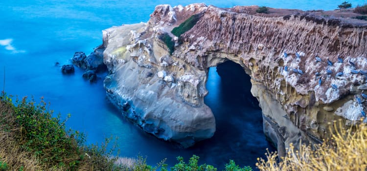 an aerial view of la jolla cave with crystal clear blue waters